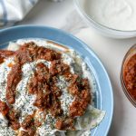 Ashak, a beloved Afghan dish of delicate dumplings filled with leeks and herbs. Served with hearty tomato sauce, creamy garlicky yogurt, and a sprinkle of aromatic dried mint. Savor the goodness of Ashak!