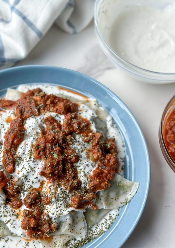 Ashak, a beloved Afghan dish of delicate dumplings filled with leeks and herbs. Served with hearty tomato sauce, creamy garlicky yogurt, and a sprinkle of aromatic dried mint. Savor the goodness of Ashak!