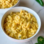 a bowl of Afghan Macaroni and Cheese with jalapeños next to it