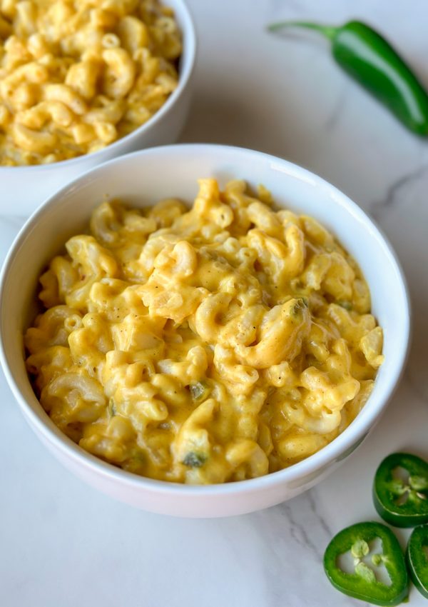 a bowl of Afghan Macaroni and Cheese with jalapeños next to it