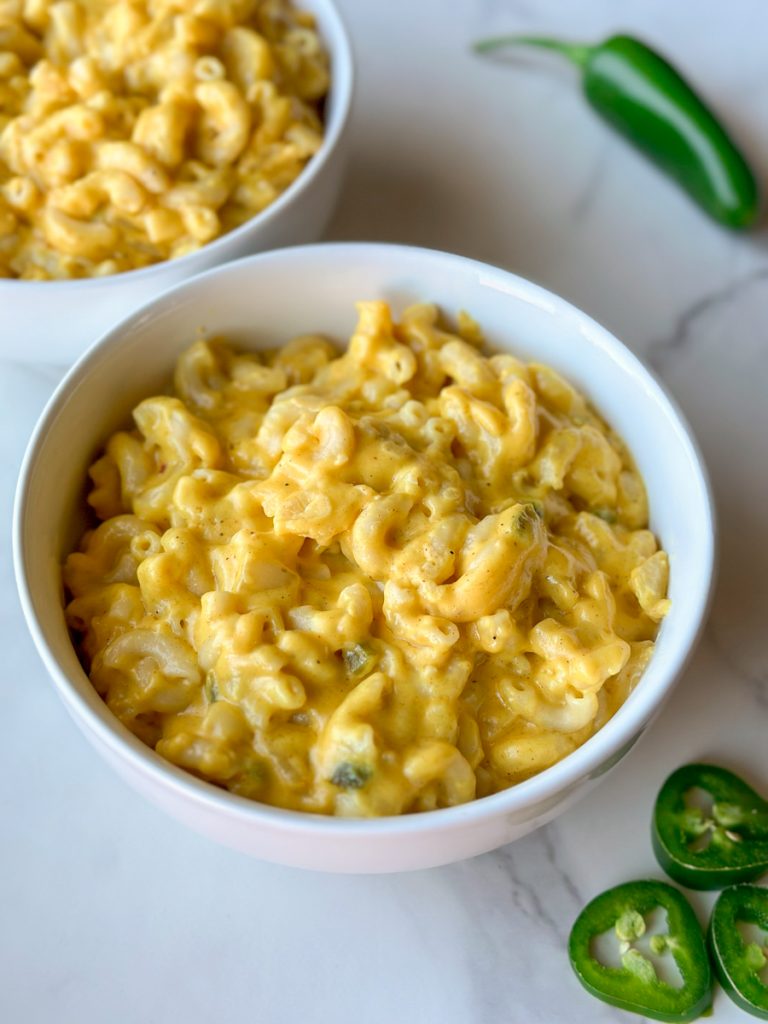 a bowl of Afghan Macaroni and Cheese with jalapeños next to it