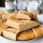 pieces of roht. an afghan sweet bread with white poppy seeds and nigella seeds on top.