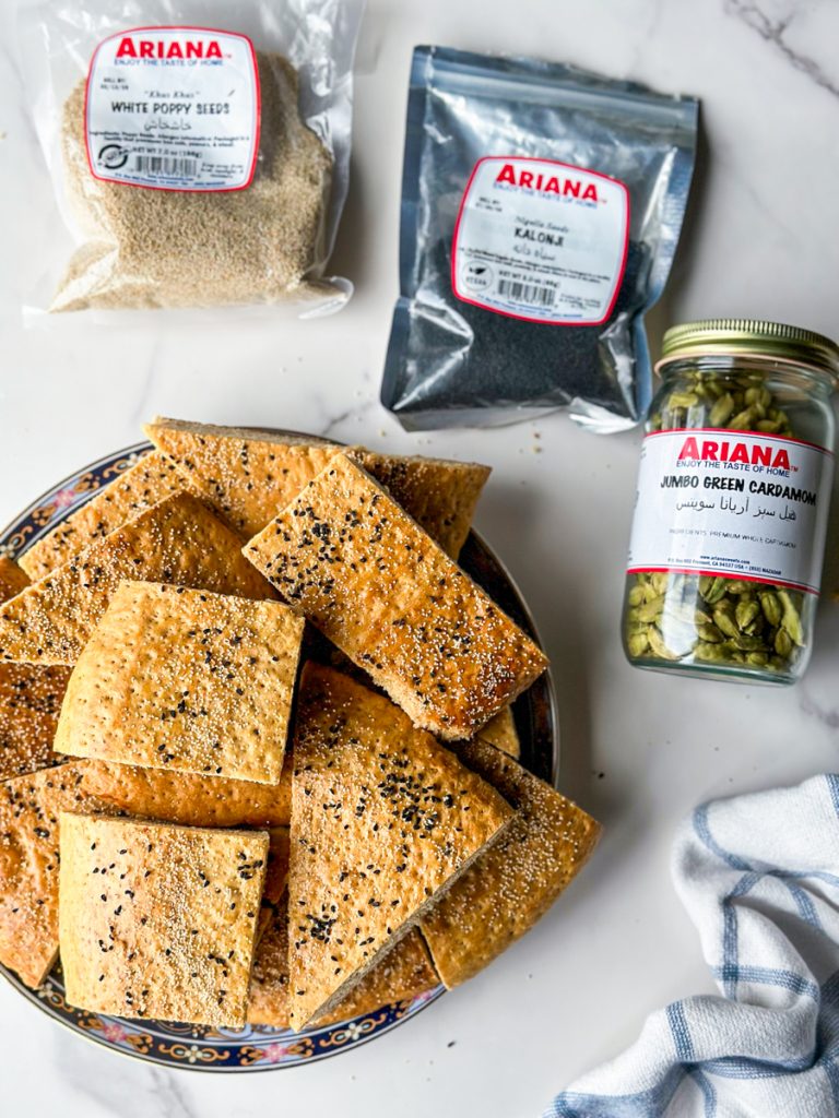 pieces of roht. an afghan sweet bread with white poppy seeds and nigella seeds on top.