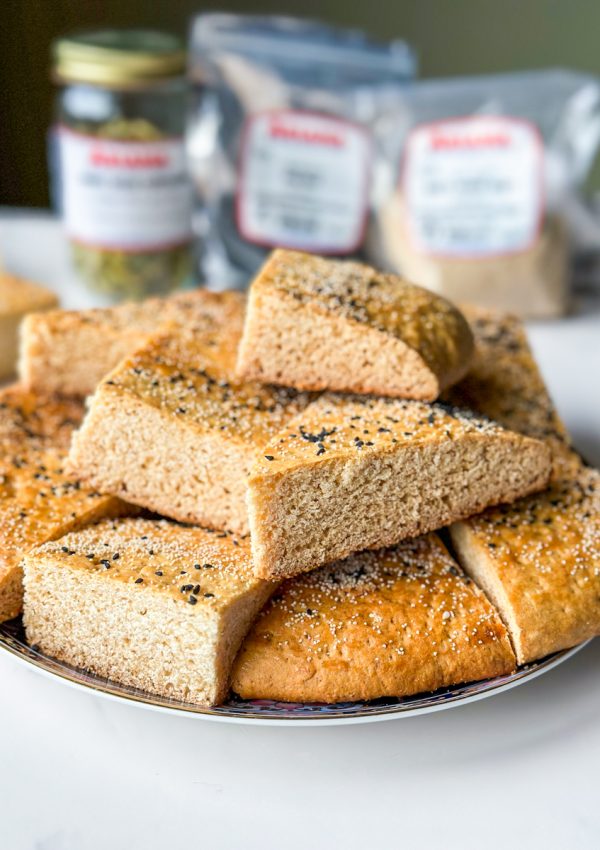 pieces of roht. an afghan sweet bread with white poppy seeds and nigella seeds on top.